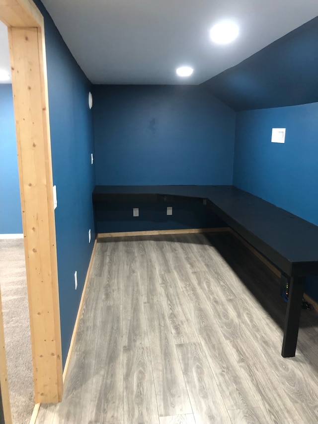 interior space with light hardwood / wood-style floors and vaulted ceiling