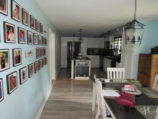 dining area with a notable chandelier and wood-type flooring