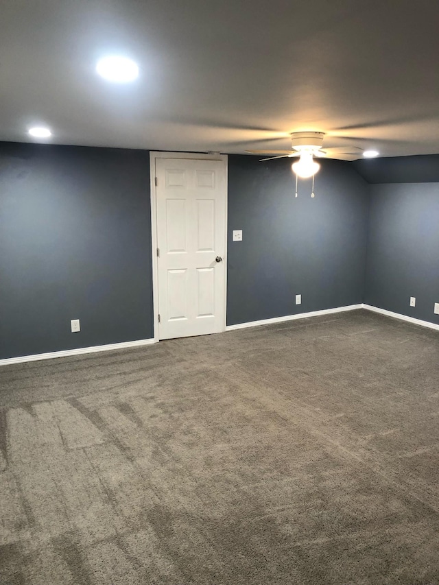 carpeted empty room featuring baseboards and a ceiling fan