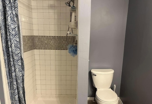 full bath with a stall shower and toilet