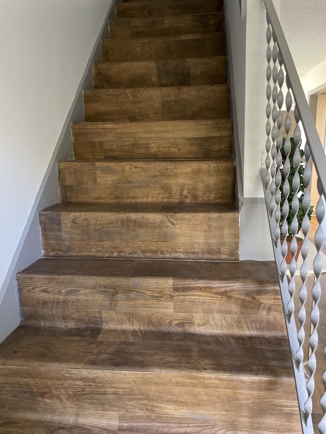 stairway with a textured ceiling