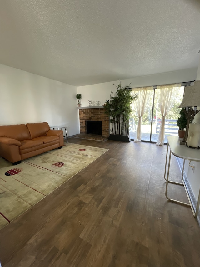 unfurnished living room with hardwood / wood-style floors, a textured ceiling, and a fireplace