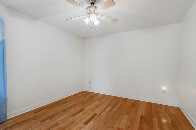 spare room featuring hardwood / wood-style floors and ceiling fan