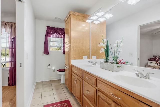 bathroom featuring vanity, toilet, and tile patterned floors