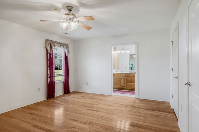 unfurnished bedroom featuring light hardwood / wood-style flooring, connected bathroom, and ceiling fan