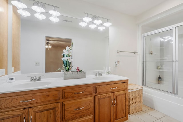 bathroom featuring vanity, combined bath / shower with glass door, and tile patterned floors