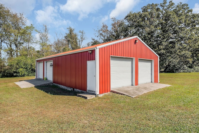 view of outdoor structure featuring a yard and a garage