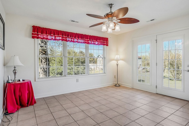 tiled spare room featuring ceiling fan