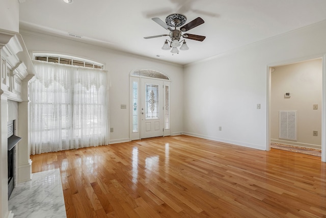 foyer featuring light hardwood / wood-style floors, crown molding, and ceiling fan