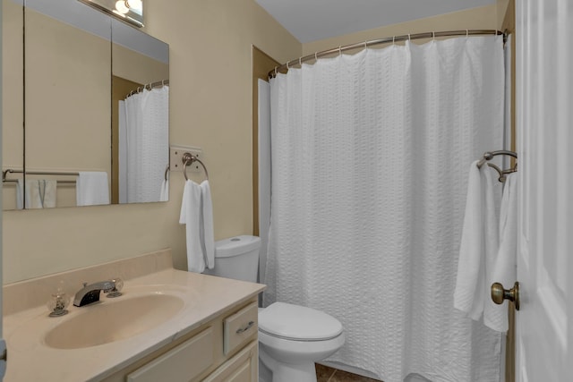 bathroom featuring tile patterned flooring, vanity, and toilet