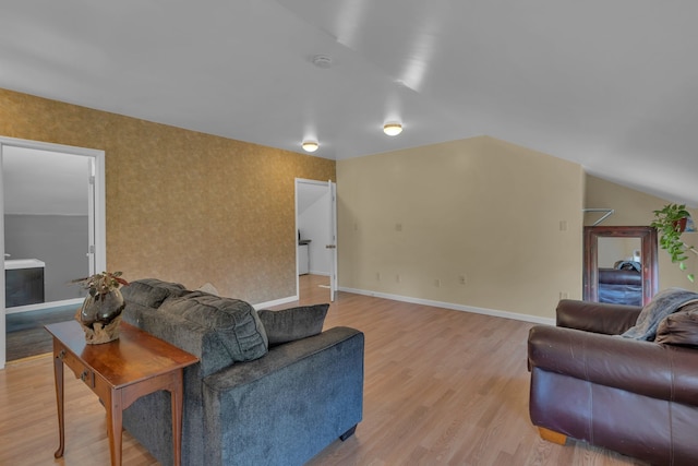 living room featuring light hardwood / wood-style floors and lofted ceiling