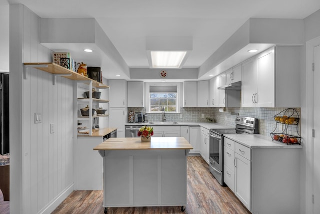 kitchen featuring white cabinetry, sink, hardwood / wood-style floors, and appliances with stainless steel finishes