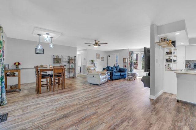 living room with ceiling fan and wood-type flooring