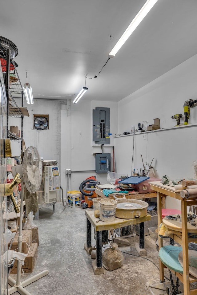 basement featuring a workshop area and electric panel