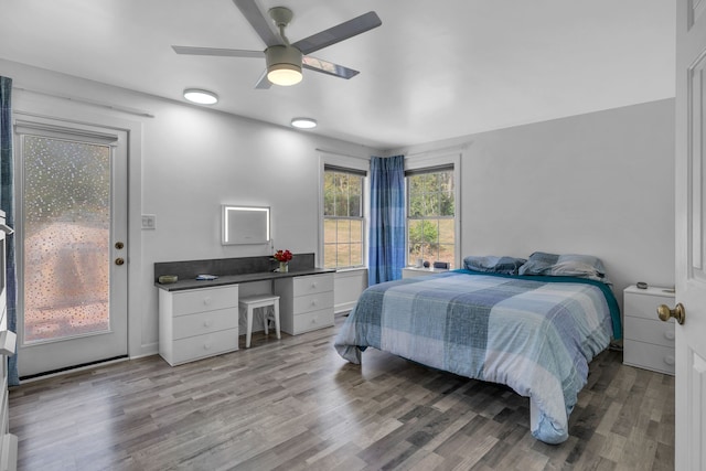 bedroom featuring hardwood / wood-style flooring, ceiling fan, and access to exterior