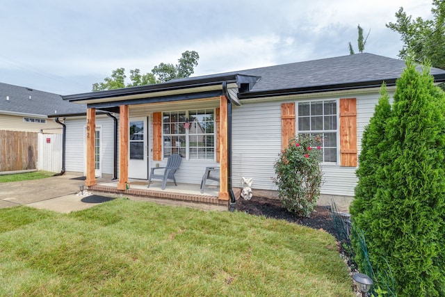 single story home featuring a front lawn and a patio