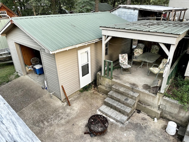 view of side of home with a fire pit