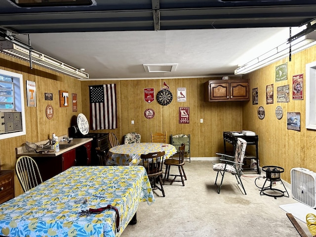 dining room featuring wood walls