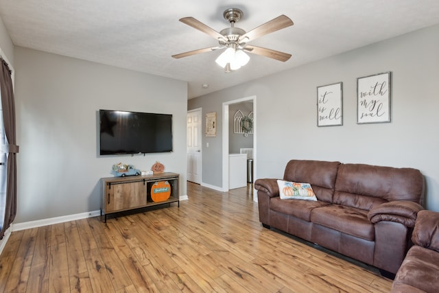 living room featuring light wood-type flooring and ceiling fan