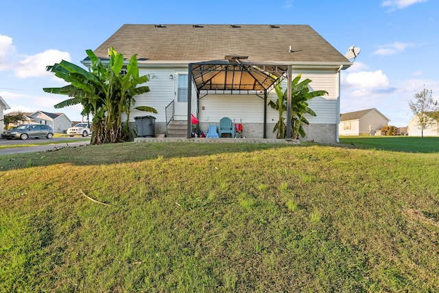 back of house with a lawn