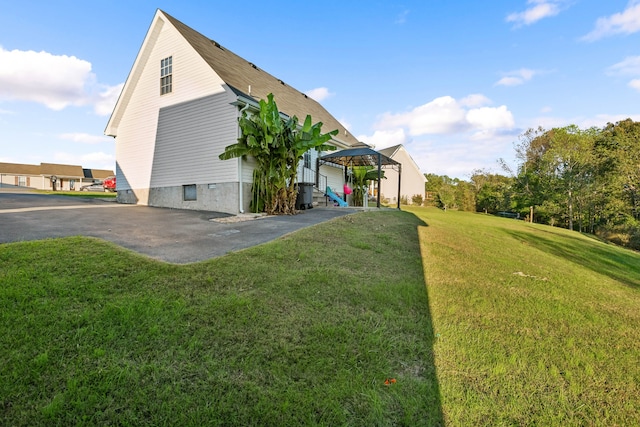 view of home's exterior featuring a lawn and a pergola