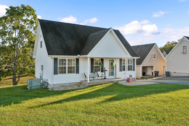 rear view of house featuring central AC and a yard