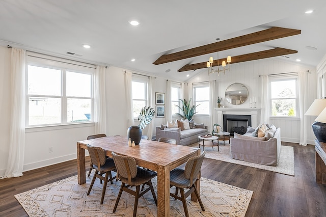 dining area with plenty of natural light, dark hardwood / wood-style flooring, and vaulted ceiling with beams