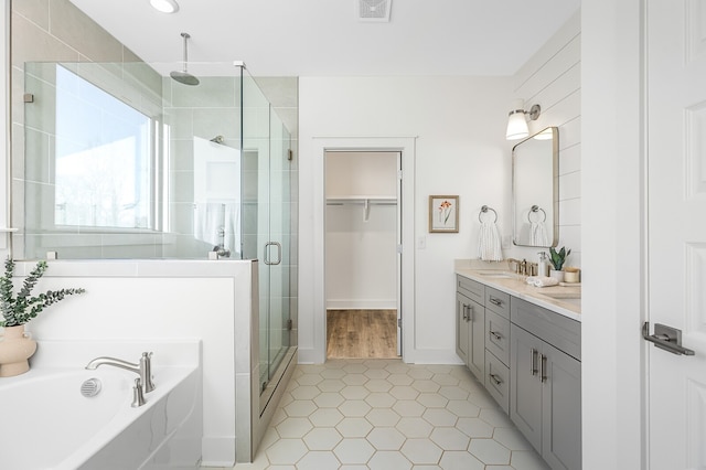 bathroom with vanity, plus walk in shower, and tile patterned flooring