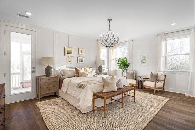 bedroom with multiple windows and dark wood-type flooring