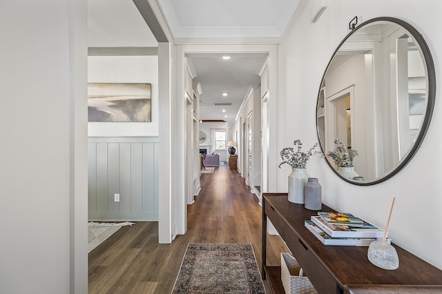 hall with crown molding and dark hardwood / wood-style flooring