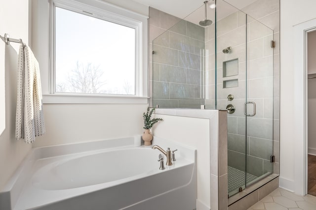 bathroom with plus walk in shower and tile patterned flooring