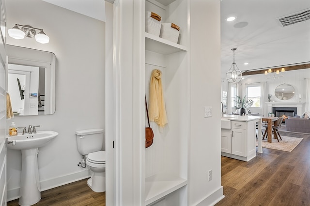 bathroom with toilet and hardwood / wood-style floors