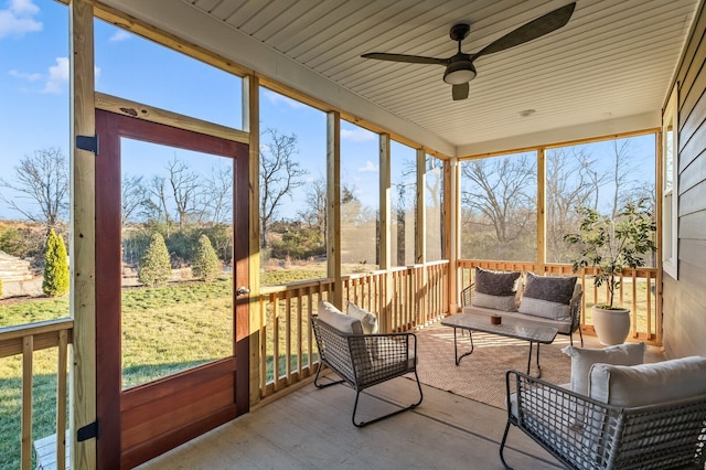 sunroom / solarium with a healthy amount of sunlight and ceiling fan