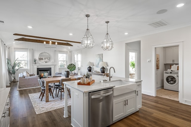 kitchen featuring washer / clothes dryer, an island with sink, white cabinetry, dishwasher, and dark wood-type flooring