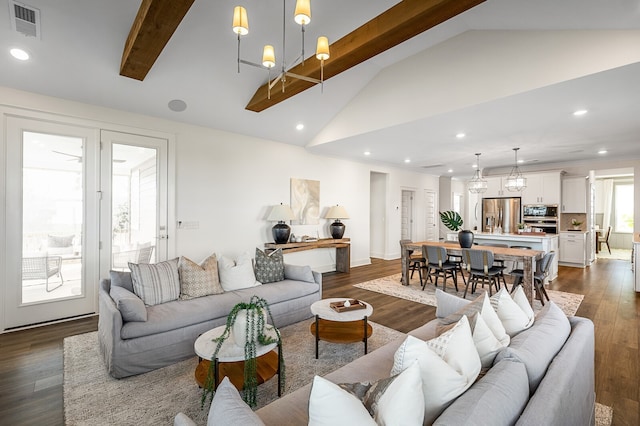 living room featuring lofted ceiling with beams, a chandelier, and dark hardwood / wood-style floors