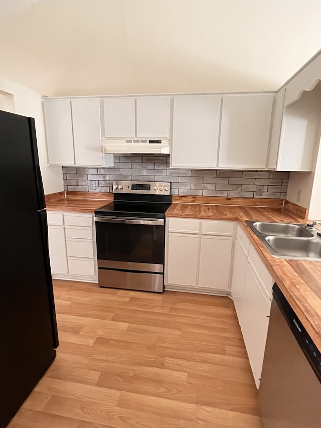 kitchen with white cabinetry, stainless steel appliances, and wood counters