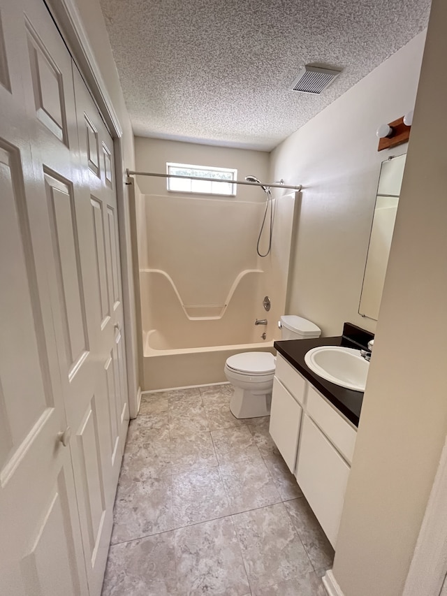 full bathroom with bathtub / shower combination, vanity, a textured ceiling, and toilet