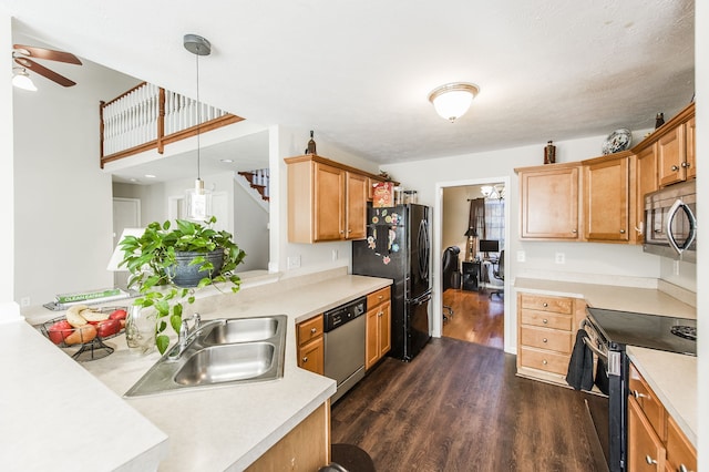 kitchen featuring appliances with stainless steel finishes, sink, ceiling fan, decorative light fixtures, and dark hardwood / wood-style floors