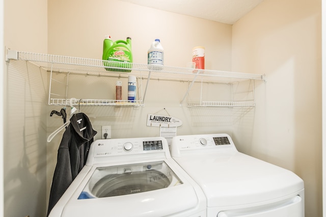 laundry area with washer and dryer and a textured ceiling