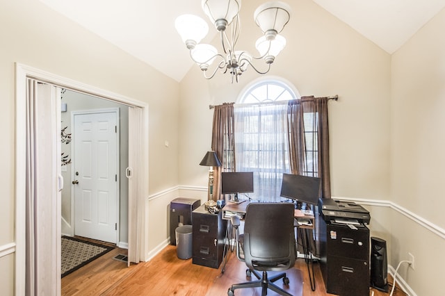 office area featuring a chandelier, vaulted ceiling, and wood-type flooring