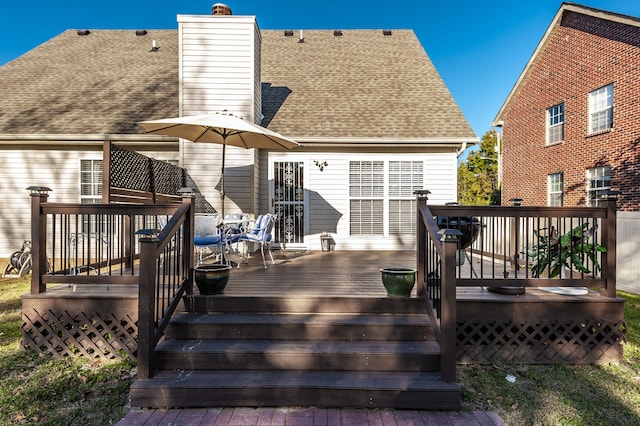 rear view of property with a wooden deck