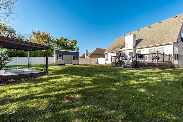 view of yard with a storage shed and a deck