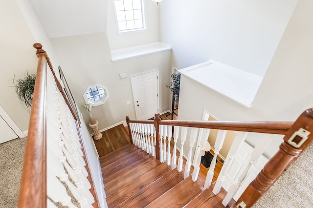 stairs featuring hardwood / wood-style floors