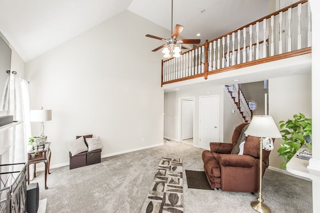 carpeted living room with high vaulted ceiling and ceiling fan