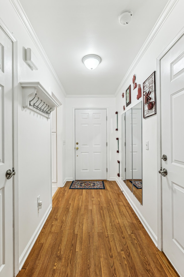 doorway featuring wood-type flooring and ornamental molding