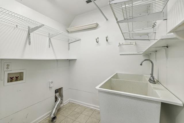 laundry area with hookup for a washing machine, light tile patterned flooring, and sink