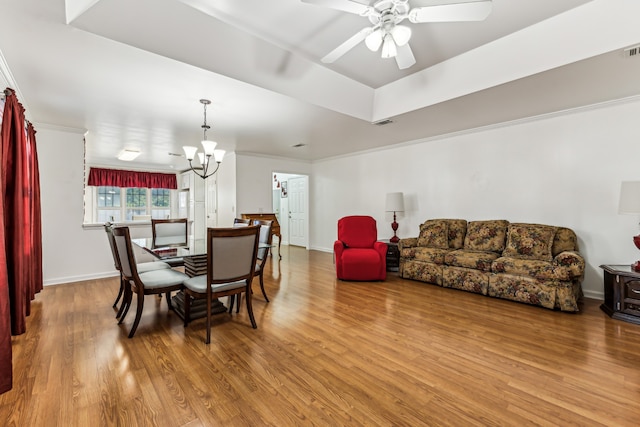 dining room featuring crown molding, hardwood / wood-style flooring, and ceiling fan with notable chandelier