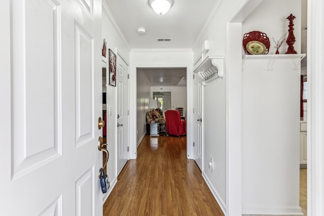 hallway featuring crown molding and wood-type flooring