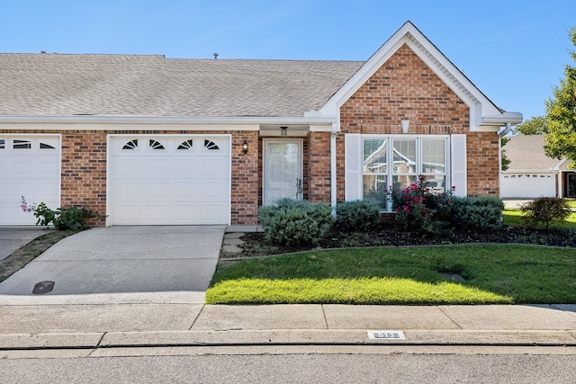 ranch-style house featuring a front yard and a garage