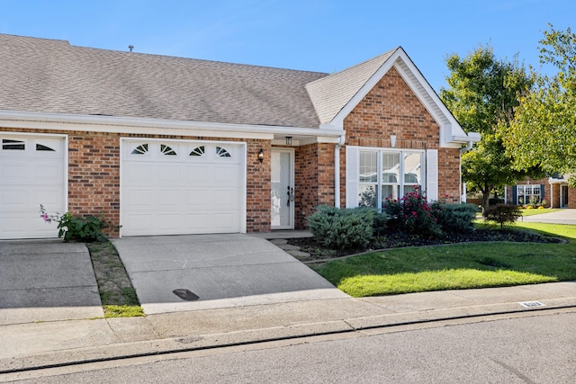 single story home featuring a front yard and a garage